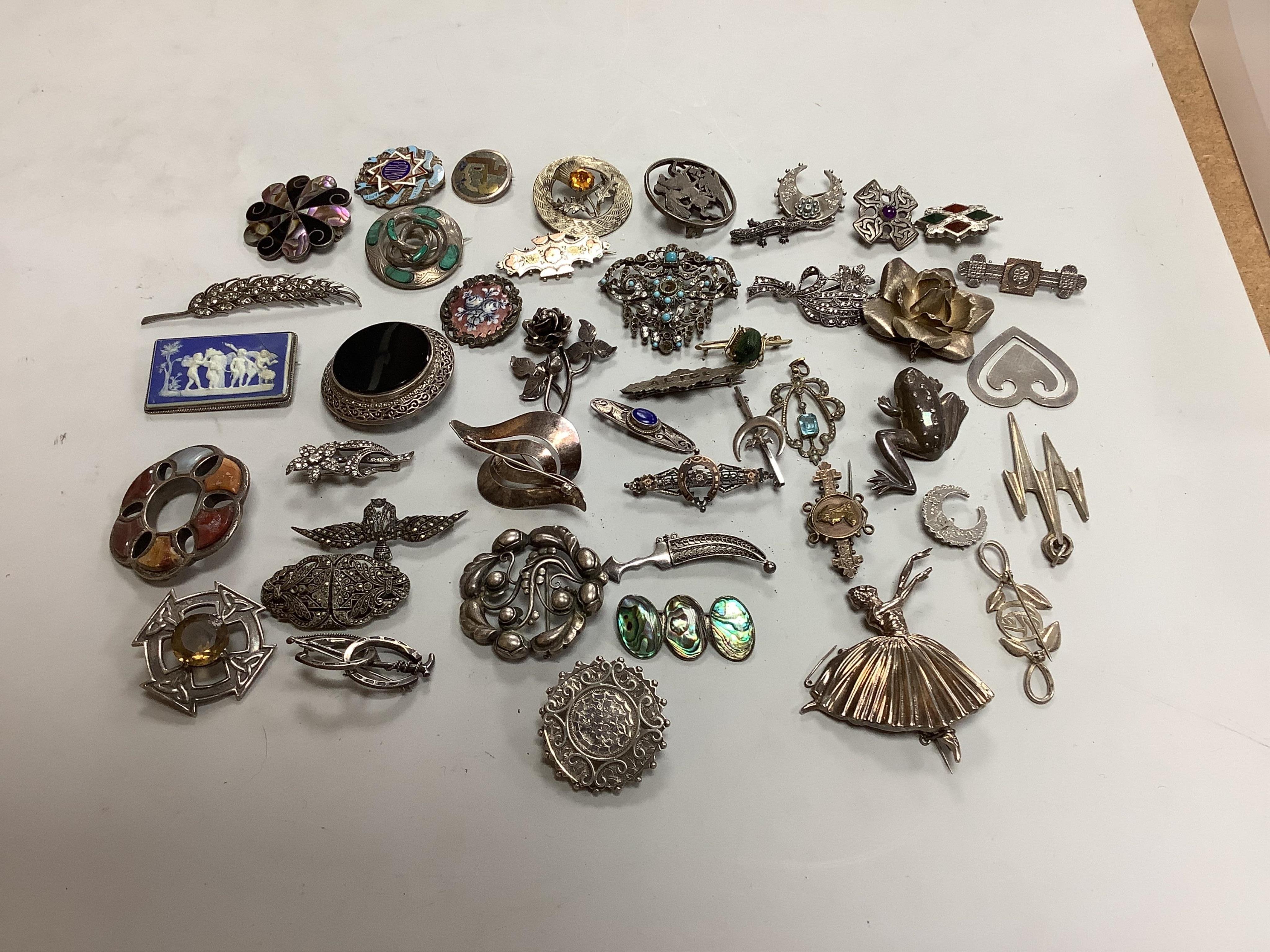 A group of silver brooches including one by Georg Jensen, comprising: a foliate brooch by Georg Jensen, 4.8cm diameter, signed Georg Jensen, numbered 158, British hallmarks, date letter d for 1959; three Scottish hardsto